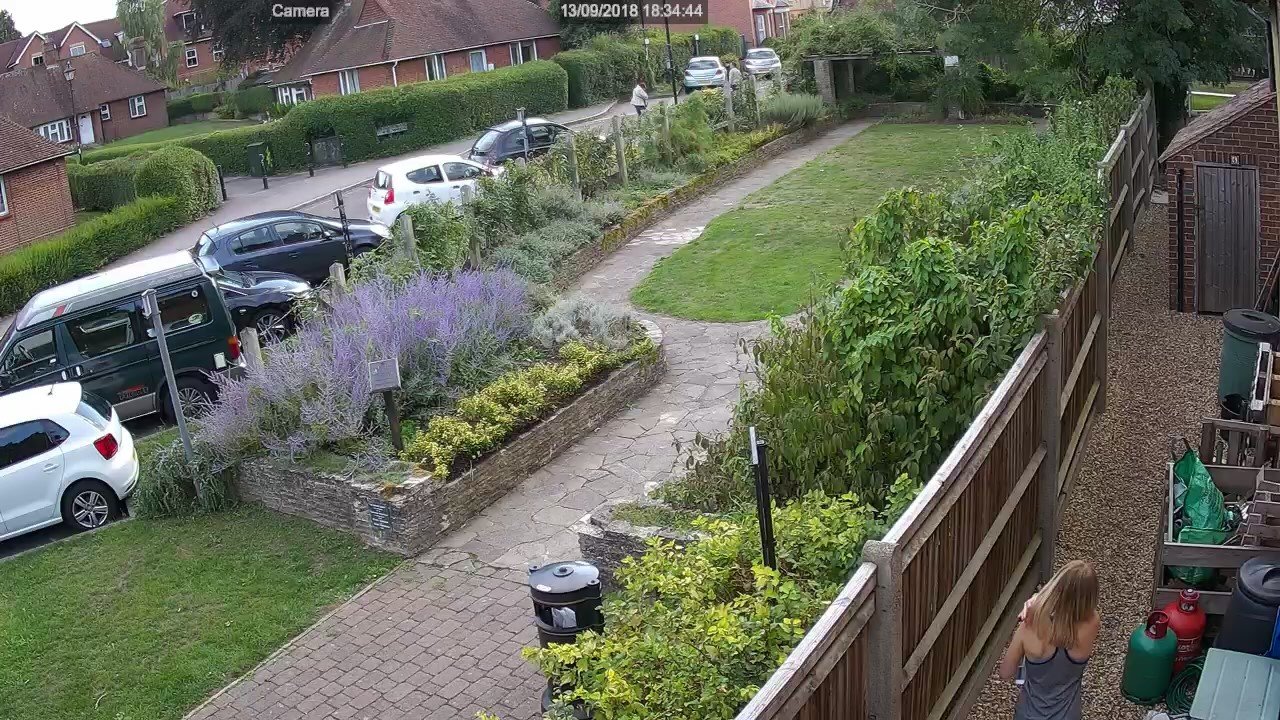 Lady going past the side of the house